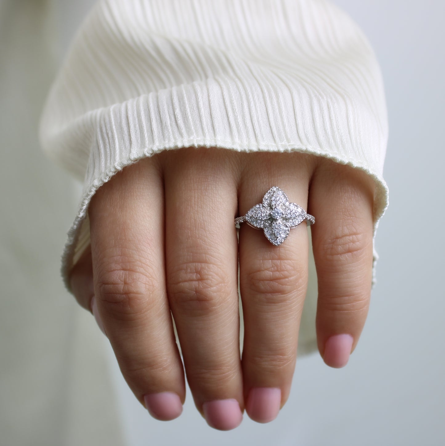 The Studded Clover ring with clear stones.